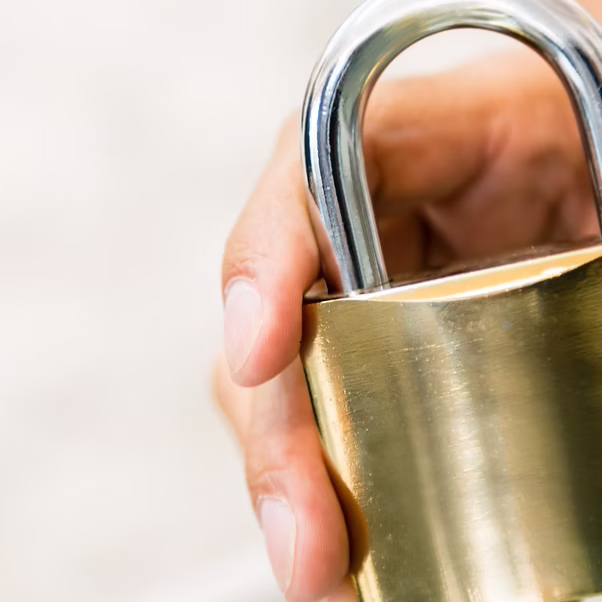Brass padlock securing a self storage unit